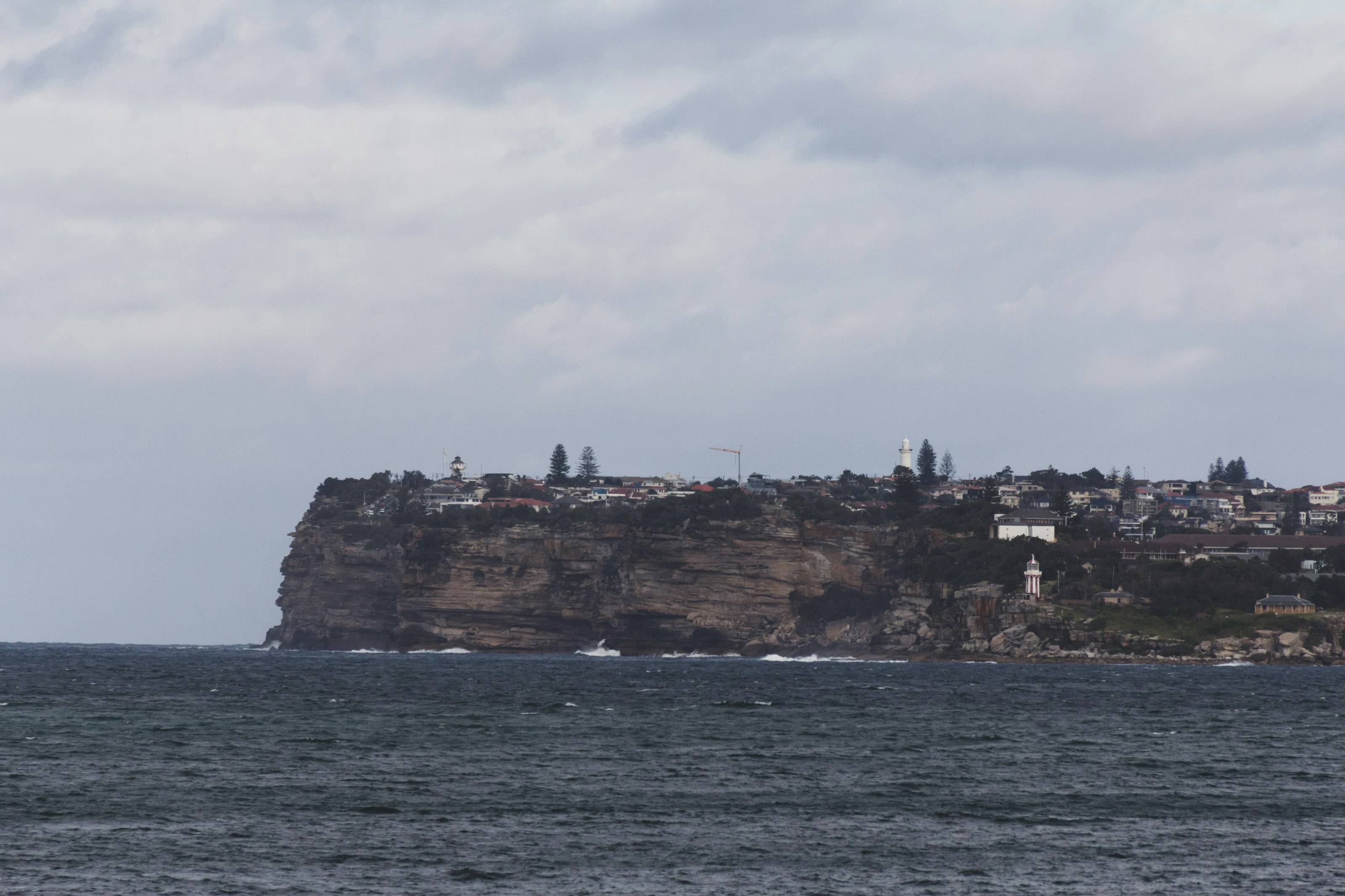 brown rock formation on body of water during daytime